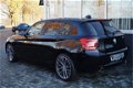 BMW 1-serie - 116i Executive Navi|Clima|Cruis|PDC 136PK Zwart Metallic - 1 - Thumbnail