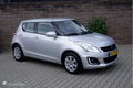 Suzuki Swift - - 1.2I 94PK 5 drs. Comfort airco/cruiscontrole/lmv15 - 1 - Thumbnail