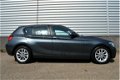 BMW 1-serie - 114i Upgrade Edition RIJKLAAR PRIJS-GARANTIE Leder interieur Navigatie Xenon - 1 - Thumbnail