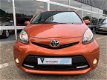 Toyota Aygo - 1.0 VVT-i Dynamic Orange, Airco, Automaat - 1 - Thumbnail