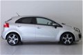 Kia Rio - 1.2 CVVT Plus Pack | RADIO-NAVIGATIE | AIRCO | CRUISE-CONTROL | 17 INCH | TREKHAAK | DONKE - 1 - Thumbnail