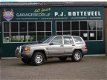 Jeep Grand Cherokee - 4.0i Laredo luxe auto met eventueel chromen sidebars aanwezig - 1 - Thumbnail