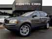 Volvo XC90 - 2.4 D5 R DESIGN AUT6 SUMMUM 185PK 7PERS LEDER SCHUIFDAK LMV PDC TREKHAAK - 1 - Thumbnail