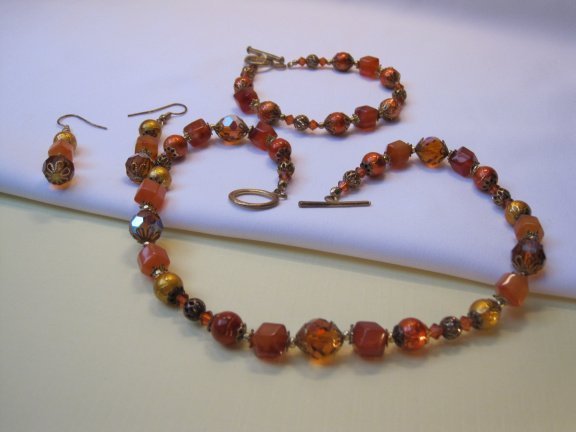Armband goudkleurig oranje/rood aurora glas kralen 19.5 cm. - Afbeelding 6