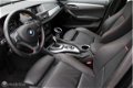 BMW X1 - 1.6d sDrive High Executive Xenon Sportstoelen Navi 19 inch lmv - 1 - Thumbnail