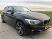 BMW 1-serie - 116i Business+ AUTOMAAT Xenon Navigatie SPORTLINE 163102 KM N.A.P 2012 - 1 - Thumbnail