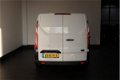 Ford Transit Custom - 2.0 TDCI - Airco - Navi - Cruise - 2017 - € 12.900, - Ex - 1 - Thumbnail