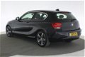 BMW 1-serie - (J) 116d High Executive Sport [xenon, navi, lederen sportstoelen] - 1 - Thumbnail