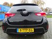 Toyota Auris - 1.6 VVT-I NOW 5DRS ECC/CRUISE/NAV/PARK.SENS/LMV/AFN.TREKHAAK - 1 - Thumbnail