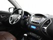 Hyundai ix35 - 2.0i 164 PK 4WD i-CATCHER + PANORAMA / LEDER / NAVIGATIE / TREKHAAK - 1 - Thumbnail