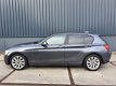 BMW 1-serie - 118i Leder Xenon Navi Professional VOL December aanbieding bij geen inruil 12450 - 1 - Thumbnail