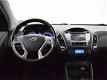 Hyundai ix35 - 2.0i AUT. 164 PK 4WD I-CATCHER + PANORAMA / LEDER / CAMERA / NAVIGATIE - 1 - Thumbnail