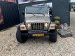 Jeep Wrangler - 4.0i AUTOMAAT *SMOKEGREY OUTLAW - 1 - Thumbnail