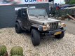 Jeep Wrangler - 4.0i AUTOMAAT *SMOKEGREY OUTLAW - 1 - Thumbnail