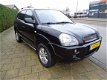 Hyundai Tucson - 2.0I CVVT STYLEVERSION 2WD - 162976 Km - Navi - Leer - Clima - 1 - Thumbnail