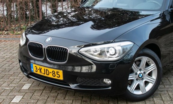 BMW 1-serie - 114i Upgrade Edition | 5drs. | navi | leer | xenon | trekhaak - 1