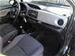 Toyota Yaris - 1.3 VVT-i Now | Lage KM-stand | Airco | 6-bak | Winterbanden | - 1 - Thumbnail