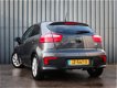 Kia Rio - 1.2 CVVT, 5 Drs, DynamicLine, Navi, 1 Ste Eigenaar, Dealer Onderh., NL-Auto - 1 - Thumbnail