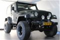 Jeep Wrangler - 4.0 I Sahara / LPG G3 / Youngtimer / Verhoogd - 1 - Thumbnail