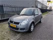 Suzuki Swift - 1.3 Comfort , 86125 km, AIRCO, CV met afst. bed., lichtmetalen velgen - 1 - Thumbnail