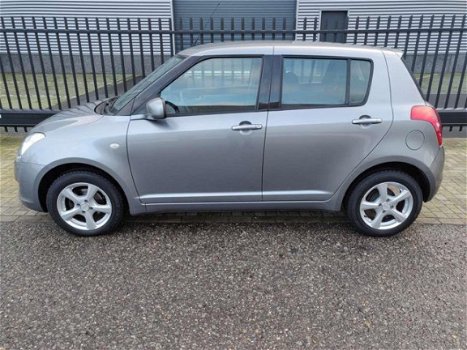 Suzuki Swift - 1.3 Comfort , 86125 km, AIRCO, CV met afst. bed., lichtmetalen velgen - 1