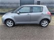 Suzuki Swift - 1.3 Comfort , 86125 km, AIRCO, CV met afst. bed., lichtmetalen velgen - 1 - Thumbnail