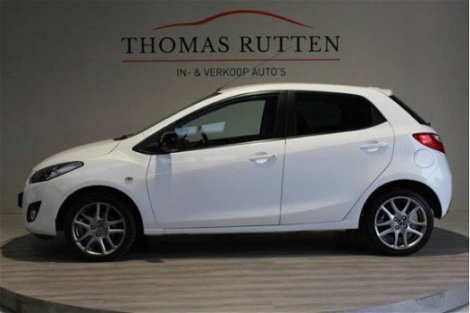 Mazda 2 - 2 1.3 Hanabi 2013/ Navi/ PDC/ Stuur bed./ Stoel verw./ Airco/ Elek ramen + Spiegels/ Boekj - 1