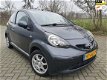 Toyota Aygo - 1.0-12V + - AIRCO - GRIJS - ELKE ZONDAG OPEN - 1 - Thumbnail