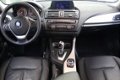 BMW 1-serie - 118i 5DRS Automaat Upgrade Edition / NAVIGATIE / SCHUIFDAK / STOELVERWARMING / LED VER - 1 - Thumbnail