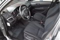 Suzuki Swift - 1.3i-16V DDiS Comfort 5-Drs Airco Navigatie Bluetooth Trekhaak Stoelverwarming - 1 - Thumbnail