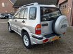 Suzuki Grand Vitara - 2.0i 4WD FreeStyle Airco Afn.trekhaak NL-auto - 1 - Thumbnail