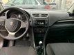 Suzuki Swift - 1.2 Comfort | Airco | Lichtmetalen Velgen | Leder Stuurwiel | Stuurwiel Bediening | - 1 - Thumbnail