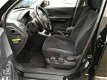 Hyundai Tucson - 2.0i Dynamic AC/Trekhaak/2WD/Ebony Black - 1 - Thumbnail