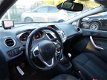 Ford Fiesta - 1.25 Titanium / airco-ecc / cruise / 5 drs / lmv / navi / pdc / metallic-lak - 1 - Thumbnail