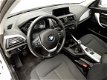 BMW 1-serie - 116D Xenon / Navigatie / Schuifdak / Keyless go / Clima / PDC / Alu 17 inch - 1 - Thumbnail