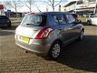 Suzuki Swift - 1.2 Comfort EASSS 5 drs, Airco, Zonnedak, Trekhaak - 1 - Thumbnail