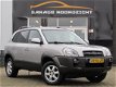 Hyundai Tucson - 2.0i 141PK Dynamic AIRCO|CRUISE CONTROL|GETINT GLAS|PDC ACHTER|LM-VELGEN - 1 - Thumbnail