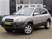 Hyundai Tucson - 2.0i 141PK Dynamic AIRCO|CRUISE CONTROL|GETINT GLAS|PDC ACHTER|LM-VELGEN - 1 - Thumbnail