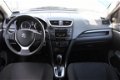 Suzuki Swift - 1.2 Comfort Automaat | Airco | PDC | Navi Actie | 5 Deurs - 1 - Thumbnail