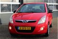 Hyundai i20 - 1.2i i-Motion (78pk) Airco /Elek. ramen voor /C.V. afstand /Radio-CD /AUX&USB /Deelbar - 1 - Thumbnail