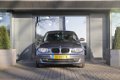 BMW 1-serie - 118i Business Line | Navigatie | Airco | Cruise Control | Licht- en regensensor - 1 - Thumbnail