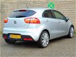 Kia Rio - 1.2 Super Pack | Airco | Cruise control | Lichtmetalen velgen 17 inch | Bluetooth | 100% O - 1 - Thumbnail