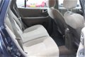 Hyundai Santa Fe - 2.0i-16V Motion (135pk) Clima/ Cruise/ Elek.Pakket/ C.V. Afstand/ 17''LMV/ Parrot - 1 - Thumbnail