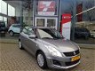 Suzuki Swift - 1.2 Comfort EASSS Airco, Radio CD/USB, Stoelverwarming, Elektrische ramen/spiegels - 1 - Thumbnail