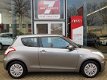 Suzuki Swift - 1.2 Comfort EASSS Airco, Radio CD/USB, Stoelverwarming, Elektrische ramen/spiegels - 1 - Thumbnail