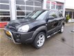 Hyundai Tucson - 2.0I CVVT STYLEVERSION Premium 2WD AIRCO/CRUISE/LEER/LEER - 1 - Thumbnail