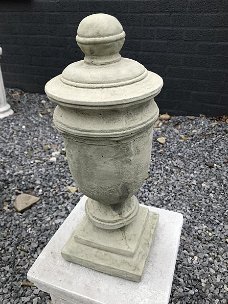 Een stenen urn, grafdecoratie in een grijze kleur - urn
