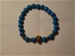 armband van blauwe kralen met goudkleurige leeuwenkop en spacers op elastiek, - 0 - Thumbnail