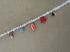 Parel ketting met verschillende bedels ibiza zomer vis ster