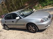 toyota avensis 1.8 sedan grijs airco. - 1 - Thumbnail